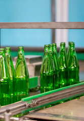Glass factory, production of glass containers. Molten glass is blown into molds. Robotics in industry. Modern technologies, robotic machines produce products. Technological work at the plant.
