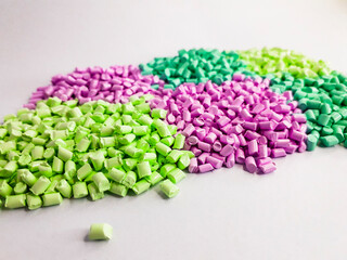 Masterbatch granules with pastel colors on a white background. Color pigment carrier polymers in the plastics industry