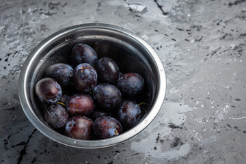 ripe plums on a dark background. Close up