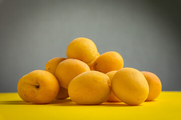 Ripe apricots on a yellow background. Healthy food.