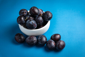 ripe plums on a dark background. Close up