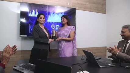 Young indian female employee receiving reward from the company manager for best performance, career job reward. worker get promotion or recognition,  businesspeople and Corporate job.  