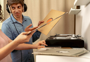 Woman listens to vinyl records on vinyl swap market
