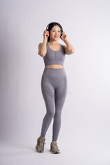 Fototapeta premium Portrait of Asian woman wearing sportswear, posing on white background.