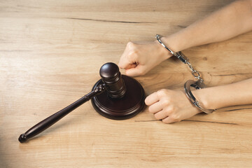 Judge Hammer for adjudication hands in handcuff. Law and justice concept. Court of law. Pronouncing...