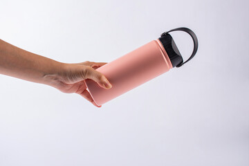 Pink bottle tumbler and hand isolated on white bakcground