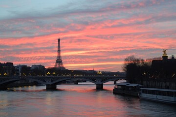Gorgeous sunset over the Eiffel Tower showcasing the artistic atmosphere of Paris, highlighting the city's romantic charm and iconic architecture during the golden hour.