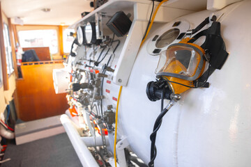 Side view of hyperbaric chamber with valves and pipes