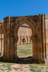Fototapeta premium The historic cloister of Monasterio de San Juan de Duero in Soria, Spain, showcasing its iconic arches and ancient stone architecture on a bright sunny day
