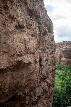 A climber trying to move on a climbing wall in Badami, Karnataka.