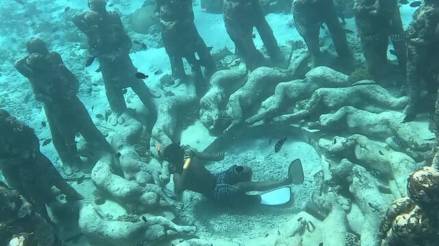 A man is swimming in a pool of dead bodies