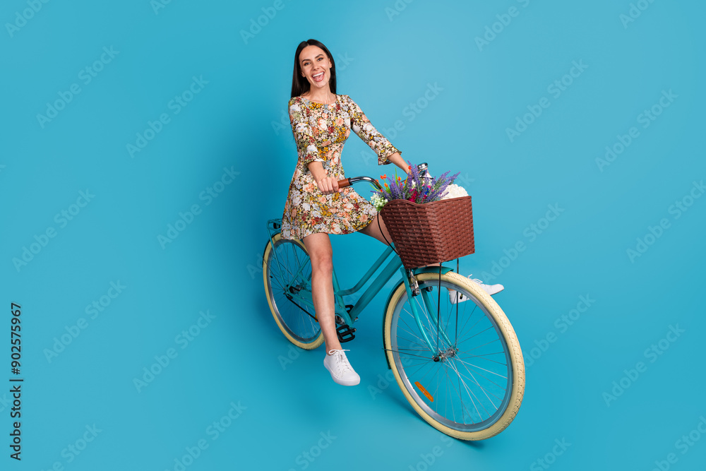 Poster full body photo of attractive young woman cycling ride bike dressed stylish flowers print clothes is