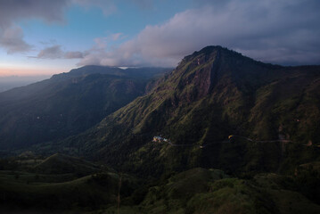 A view of a towering mountain with heavy clouds in the sky, captured in Sri Lanka.