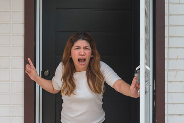 An asian woman standing right at the door shouts at her neighbor to shut up and stop making noise....