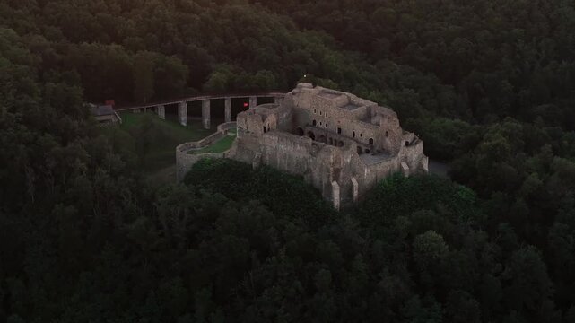 Neamt Fortress (Cetatea Neamtului in Romanian language). 4K aerial close up video with a beautiful sunrise over this iconic fortress from Moldova, Romania. Travel to Romania history landmarks.