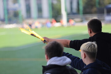 enthusiastic fans with a flare at the match