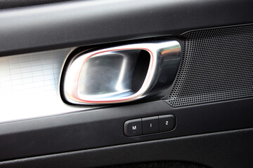 Fototapeta premium Door handle for new car. Metal door trim with seat memory control function.