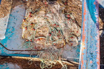  Fishing Net Is Neatly Spread Out In A Boat, Ready For An Exciting Day On Serene Waters. This Scene...