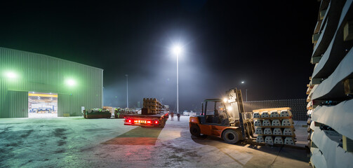 Industrial Night Scene with Railway Sleepers and Forklift