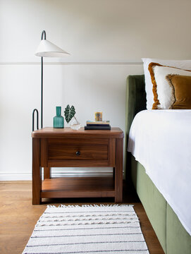 Cozy bedroom with stylish wooden bedside table