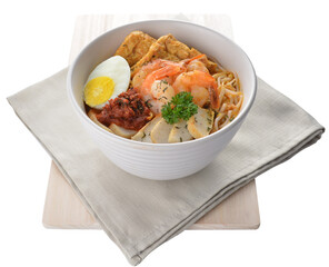 spicy nyonya noodlel malay laksa mee soup with seafood prawn, fish cake, egg, bean curd and chilli sambal thick gravy sauce in bowl on white background asian halal food cuisine menu for cafe design