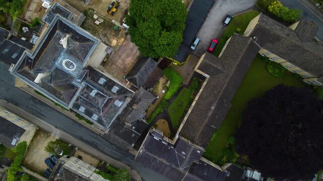 Experience dynamic descending drone footage as the camera moves downward over Cirencester&rsquo;s buildings, revealing intricate details of the urban landscape and architectural features from above.