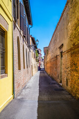 A view down a quiet side street in Imola, Italy  in summertime