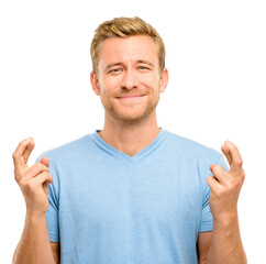 Studio, portrait and man with fingers crossed for hope, opportunity or promise for chance. Wish, faith and face of male person with anxiety praying for good news, results or luck on white background