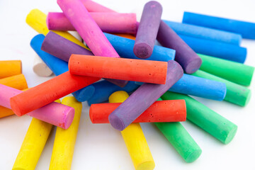 Set of colorful chalks for the board and the street. Drawing chalk stick, back to school background. Heap draw equipment. Childhood