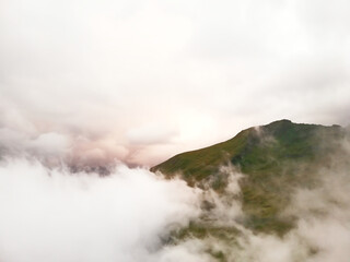 Mystical mountain landscape in the clouds. Sunset deep view, all white