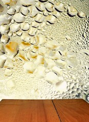 Wooden table and a background of beer drops on the glass surface - photo prepared for photomontage for pasting the object