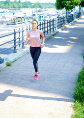 Brunette haired woman running in urban scene