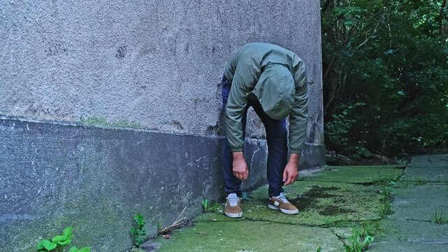 Fenantyl Drug Addict Junkie under Influence of Psychoactive Substance Narcotic Standing in Folded Zombie Pose in Dangerous Shabby Neighbourhood Alley