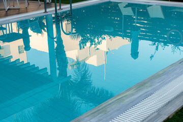 Empty luxury hotel swimming pool view reflecting the surrounding