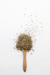 ground Italian herbs in the wooden spoon