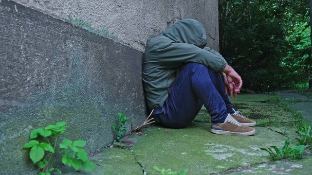 Fenantyl Drug Addict Junkie under Influence of Psychoactive Substance Narcotic Sitting in Dangerous Shabby Neighbourhood Alley