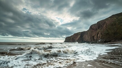 Stormy sky and cliffs as ocean waves crash on sandy beach