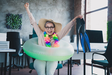 Photo of smiling lucky mature lady accountant formalwear celebating summer trip indoors workplace...