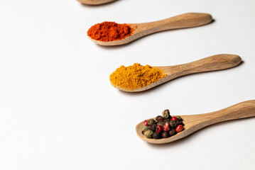 Multiple spices on the wooden spoons, chili, spice mix, turmeric, cumin, Italian herbs
