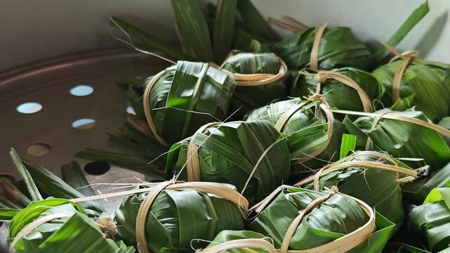 Sticky Rice, Banana, Black Beans, and Coconut Milk Wrapped in Pandanus Leaves.