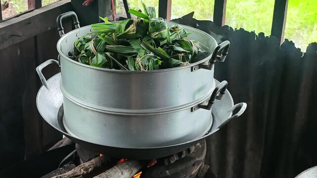 Sticky rice with banana wrapped in pandanus leave. Ready to steam.