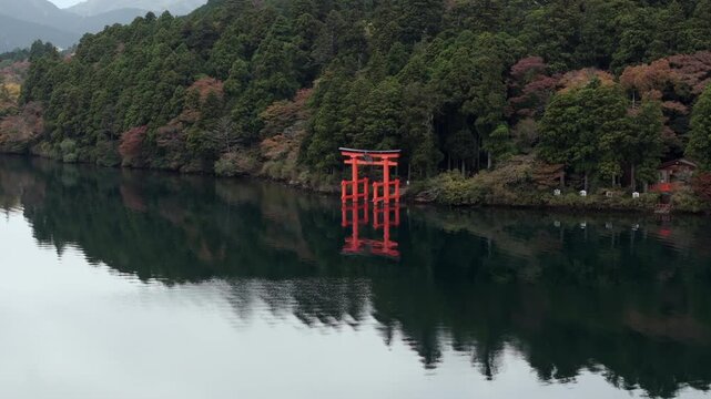 Aerial view the iconic red torii gate on the shore of Lake Ashi during the autumn season in Hakone, Japan. 