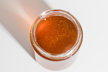 Fresh golden honey in studio light, a jar of pure sweetness perfect for culinary delights