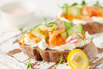 Sandwich with vegetables and salmon on a wooden board. Ciabatta sandwich.