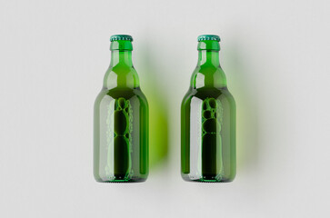Green steinie beer bottle mockup on a grey background.