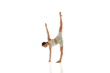 Half Moon pose. Athletic young woman practices against white studio background, training strength and body awareness. Concept of beauty, mindfulness and balance, mental health, concentration. Ad