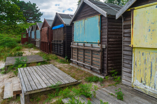 Middle Beach, Studland, UK - July 23rd 2024: Row of wooden beach huts.
