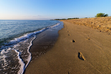 Footprints on Taverna beach in eastern coast of Corsica island