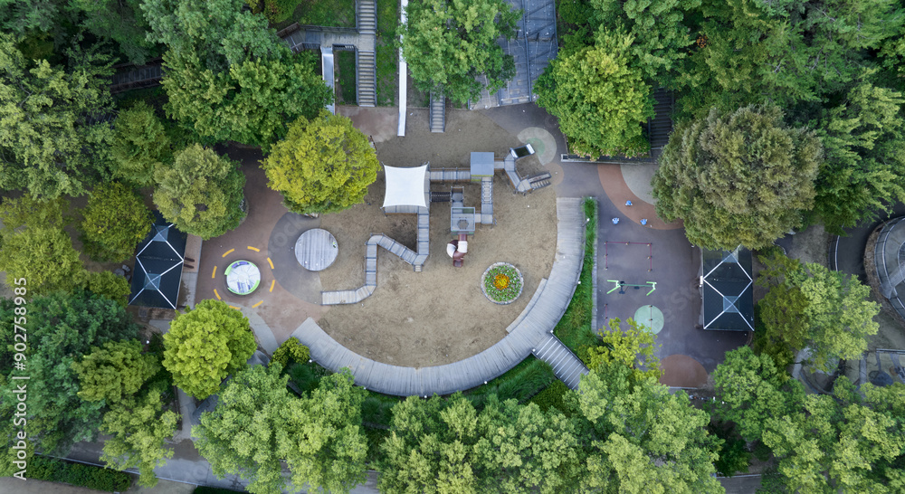 Wall mural Seongsu-dong, Seongdong-gu, Seoul, South Korea - September 18, 2022: Aerial and top angle view of playground and trail amid forest at Seoul Forest in summer
