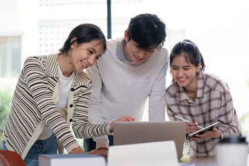 Group of Student Collaboration on a Project with a Laptop in a Modern Classroom Setting